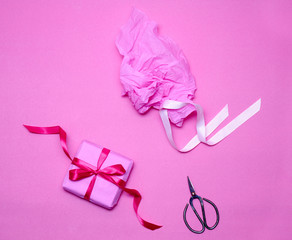 Box gift, paper and antique shears on pink background