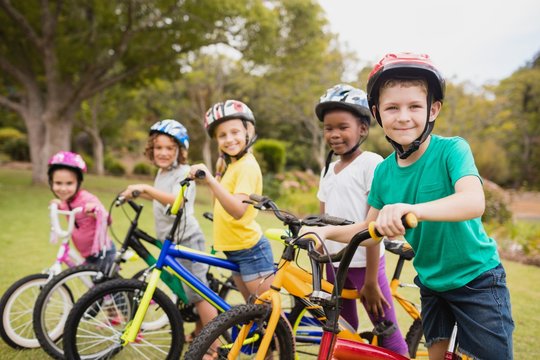 Smiling children posing with bikes