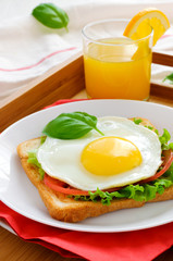 Toast with fried egg, and orange juice