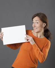 fun beautiful woman holding a copy space message panel