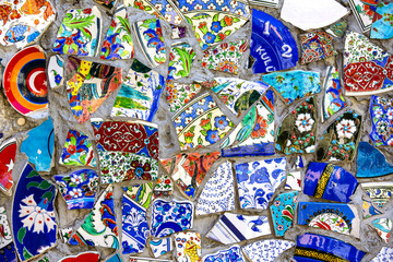 Wall with broken ceramic plates colored fragments