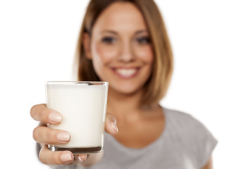 beautiful young woman holding a glass of milk