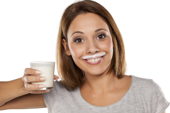 happy young beautiful woman with a yogurt mustache
