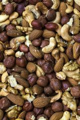 Background mix of nuts and raisins shot close-up