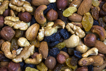 Background mix of nuts and raisins shot close-up