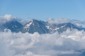 Fototapeta na wymiar Mountain peak in the clouds Rosa Khutor