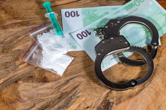 Illegal drugs, money and handcuffs