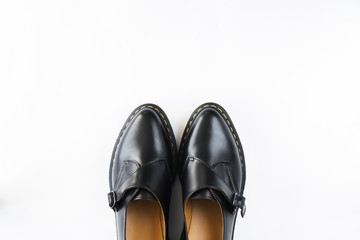 fashion female black shiny leather shoes white background