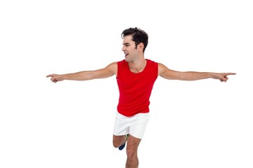Excited male athlete with arms outstretched