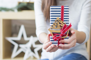 Woman Holding Gift Tied with Red Ribbon