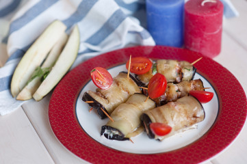 Eggplant rolls with walnuts, chicken and tomato