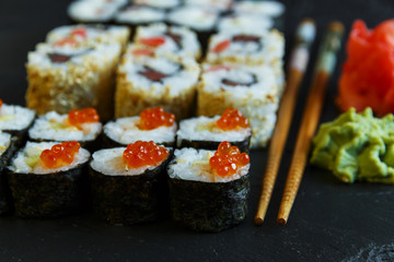  sushi rolls served on stone slate red caviar