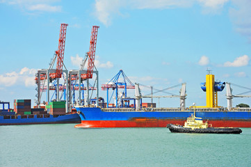 Tugboat assisting bulk cargo ship