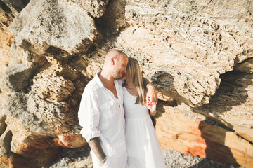 Fototapeta premium Happy romantic fashion couple in love have fun on beautiful sea at summer day