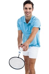 Badminton player holding a racquet ready to serve 