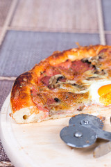 Homemade delicious pizza with egg mushrooms ham