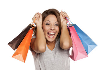 happy woman posing with shopping bags on a white background.