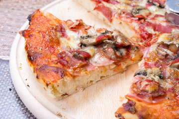 Closeup macro pizza slice on the wooden board