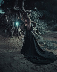 Dark witch casts a spell. In the background, mystical atmosphere. Photoshoot fantasy. Model big,...