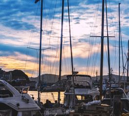 Yacht masts silhouette at beautiful twilight sky background in Bergen city marina, Norway
