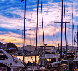 Yacht masts silhouette at beautiful twilight sky background in Bergen city marina, Norway