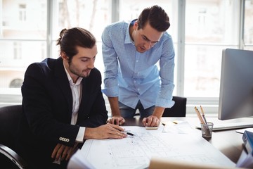 Interior designer with male colleague working in office
