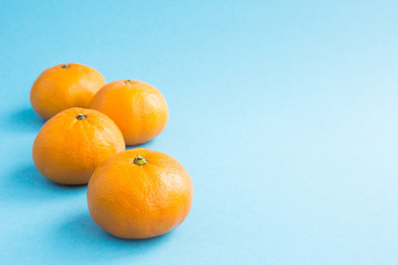Tangerines on a blue background. Mandarin, orange