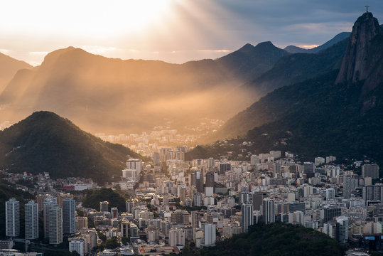 Sun is shining through the clouds on the Rio de Janeiro city, View from the Sugarloaf Mountain
