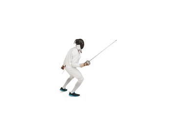 Man wearing fencing suit practicing with sword