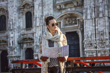 woman in front of Duomo in Milan with map looking into distance