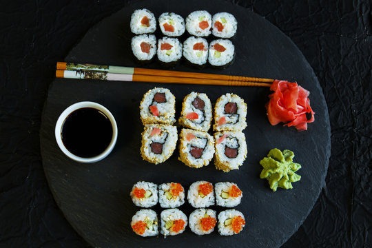  sushi rolls served on stone slate red caviar