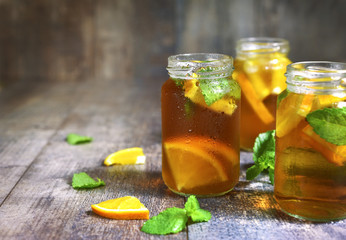 Orange iced tea in a glass jar.
