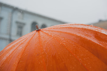 rain drops falling from a orange umbrella