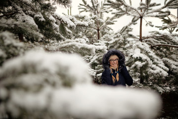 girl in a pine forest in the snow