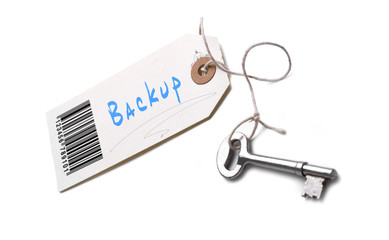A silver key with a tag attached with a Backup concept written o