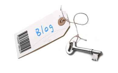A silver key with a tag attached with a Blog concept written on