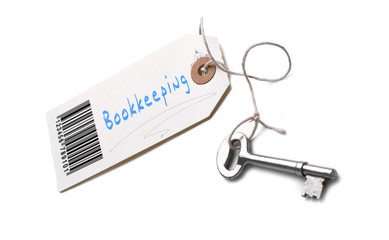 A silver key with a tag attached with a Bookkeeping concept writ