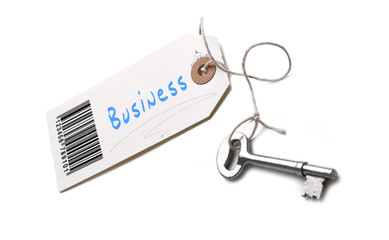 A silver key with a tag attached with a Business concept written