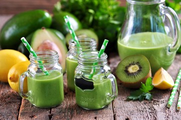 Green smoothies from fresh kiwi, avocado, apple, lemon, baby spinach and parsley.  Healthy eating.