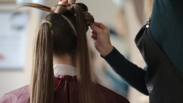 Stylist, Hairdresser is Making The Hairstyle For a Woman with Long Hairs, Combing the Wet Hairs before making a hairstyle, hairdresser's hands close up, hairs close up, Red Earrings, Barbershop,