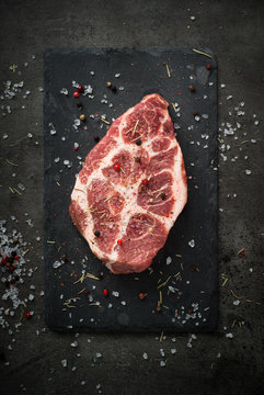 Raw meat pork steak on black. Food background.