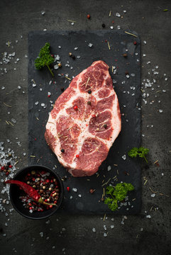 Raw meat pork steak on black. Food background.