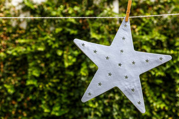 A beautiful white star hanging from a rope
