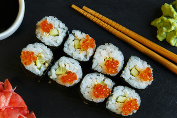  sushi rolls served on stone slate red caviar