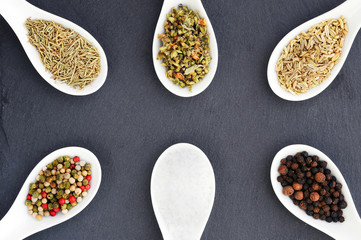 Black, white and red pepper, rosemary, basil, fennel and salt spices. Background of spices. Background frame of spices.