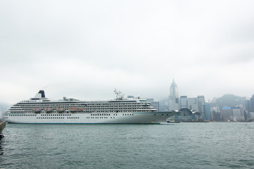 Fototapeta na wymiar Cruiser ship trough downtown skyline landscape panorama in Hongkong island. skyscrapers horizontal composition