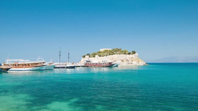 Kusadasi Turkey G&uuml;vercinada Pigeon Island with Byzantine Castle with Boats on Clear Exotic Blue Aegean Sea Water in Perfect Sunshine Weather