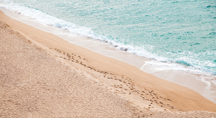 Sea shore. Human footprints on a sandy beach