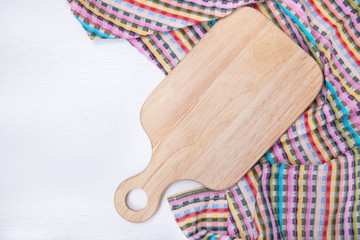 chopping board and towel on a white wooden background