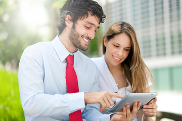 Business people using a digital tablet